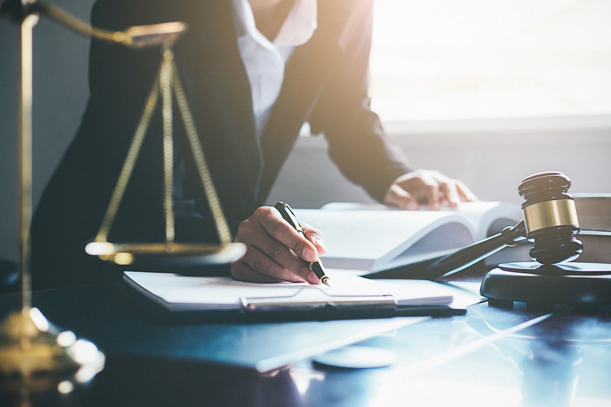 person reviewing forms at a lawyer's desk