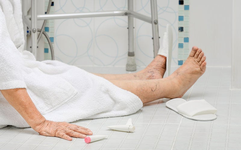 Elderly person that has fallen on tiled floor