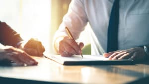 Two men reviewing paperwork to determine how to pursue personal injury compensation