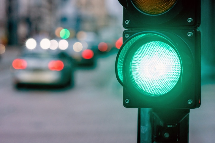 A green traffic light at a city intersection.