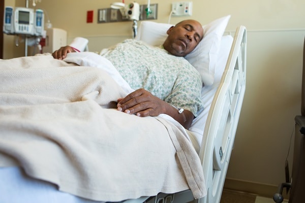 man in hospital bed