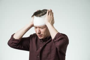brain injury patient putting his hands on his head