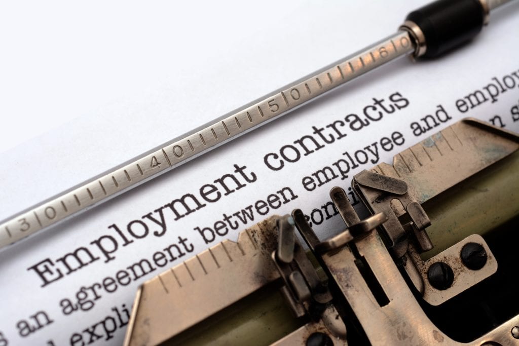 employment contract in a typewriter