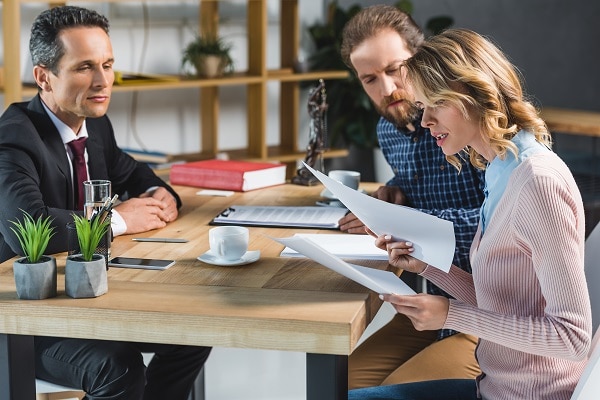 Image of a couple reviewing a will with a mediator.