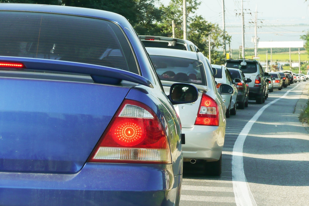 A view from behind a car that is in a long line of stopped traffic