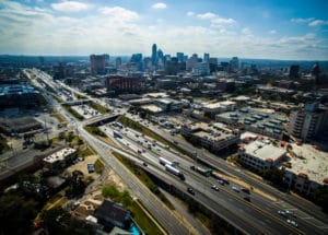 An aerial view of an interstate in Austin TX with moderate traffic during the day