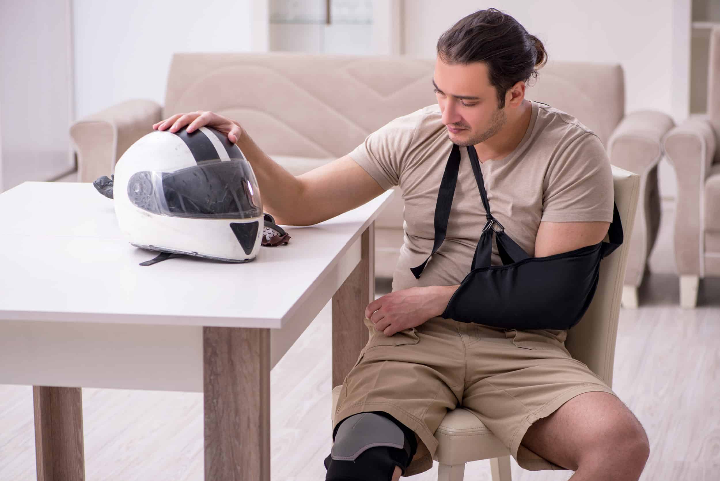 Injured person looking at a motorcycle helmet